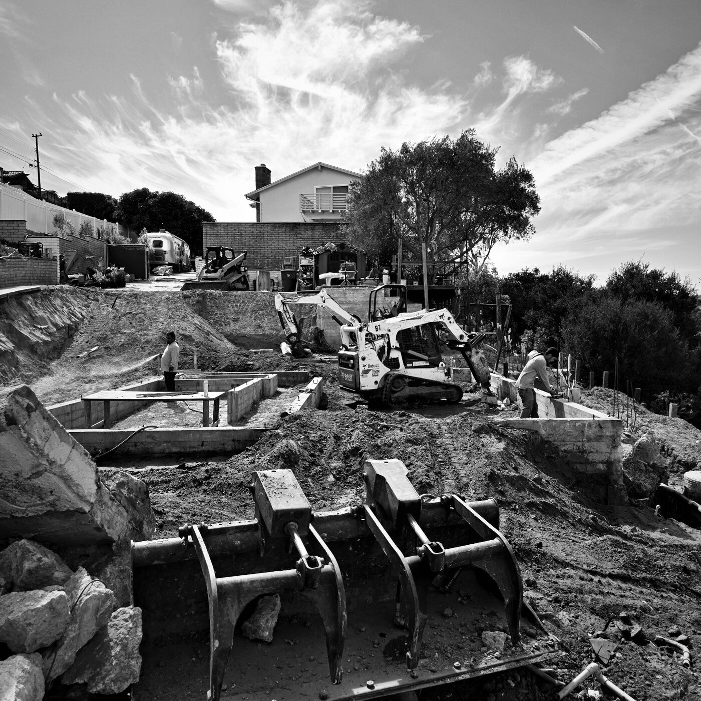 Excavation equipment working around concrete footings at 4501 Via Corona