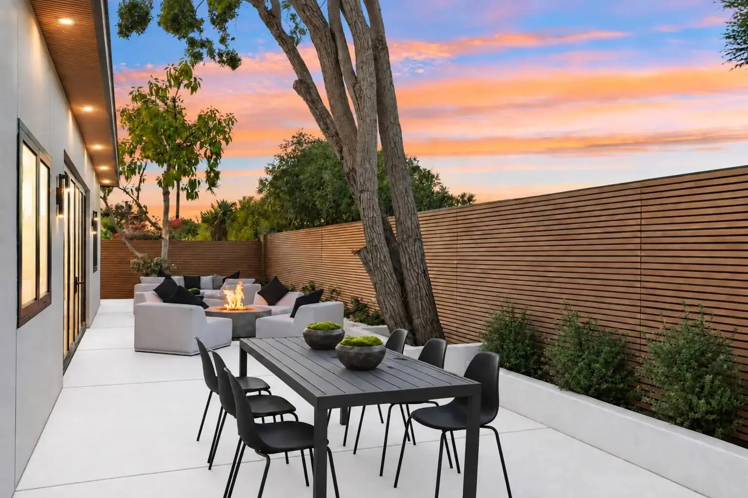 Side yard dining and fire lounge at twilight